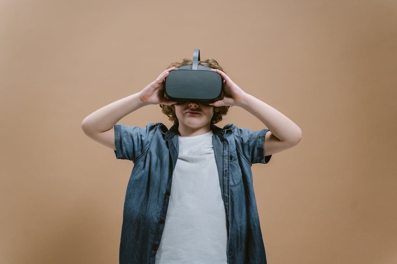 Representative Image. A kid is using VR Goggles. Photo Source: Tima Miroshnichenko (Pexels)