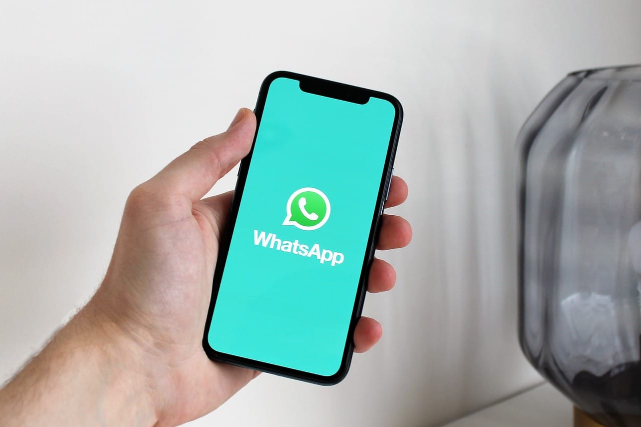 Representative Image. A hand holding a smartphone with the WhatsApp application open. Photo Source - Antonbe (Pixabay)