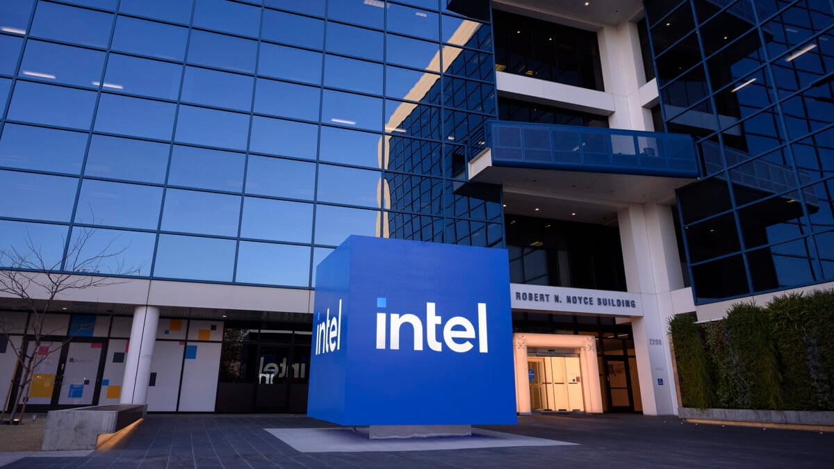 Intel headquarters building exterior showing blue Intel logo sign in front of modern glass office building with white architectural elements in Santa Clara California