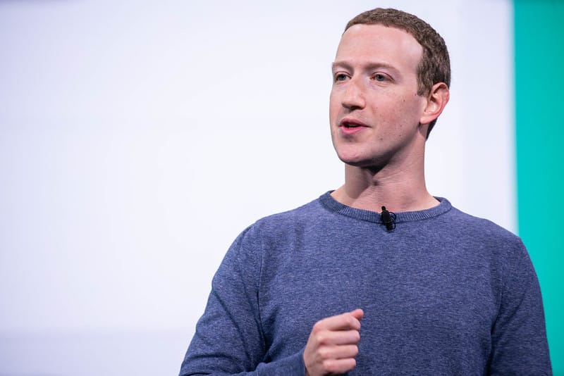 Mark Zuckerberg speaking at Facebook's F8 Developer Conference in 2019, wearing a blue sweater against a teal background.