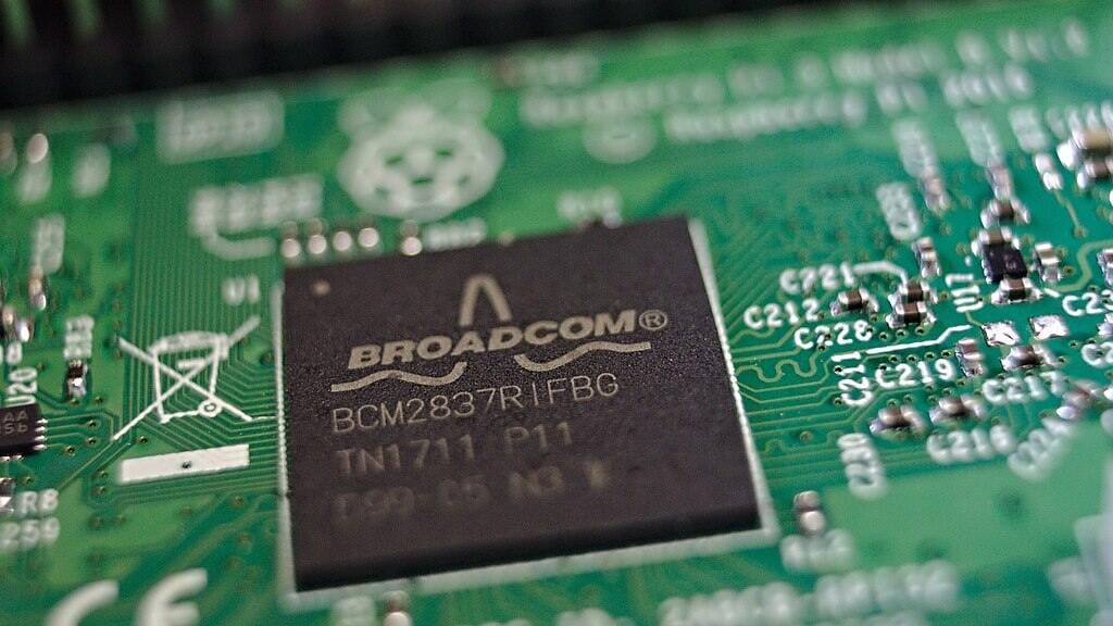 Close-up of a Broadcom BCM2837 system-on-chip processor mounted on a green Raspberry Pi 3 circuit board.