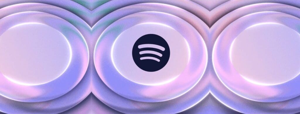 Circular sound wave design in pastel purple and blue gradients with the Spotify logo in the center against a dark background, representing the company's new lossless audio offering.