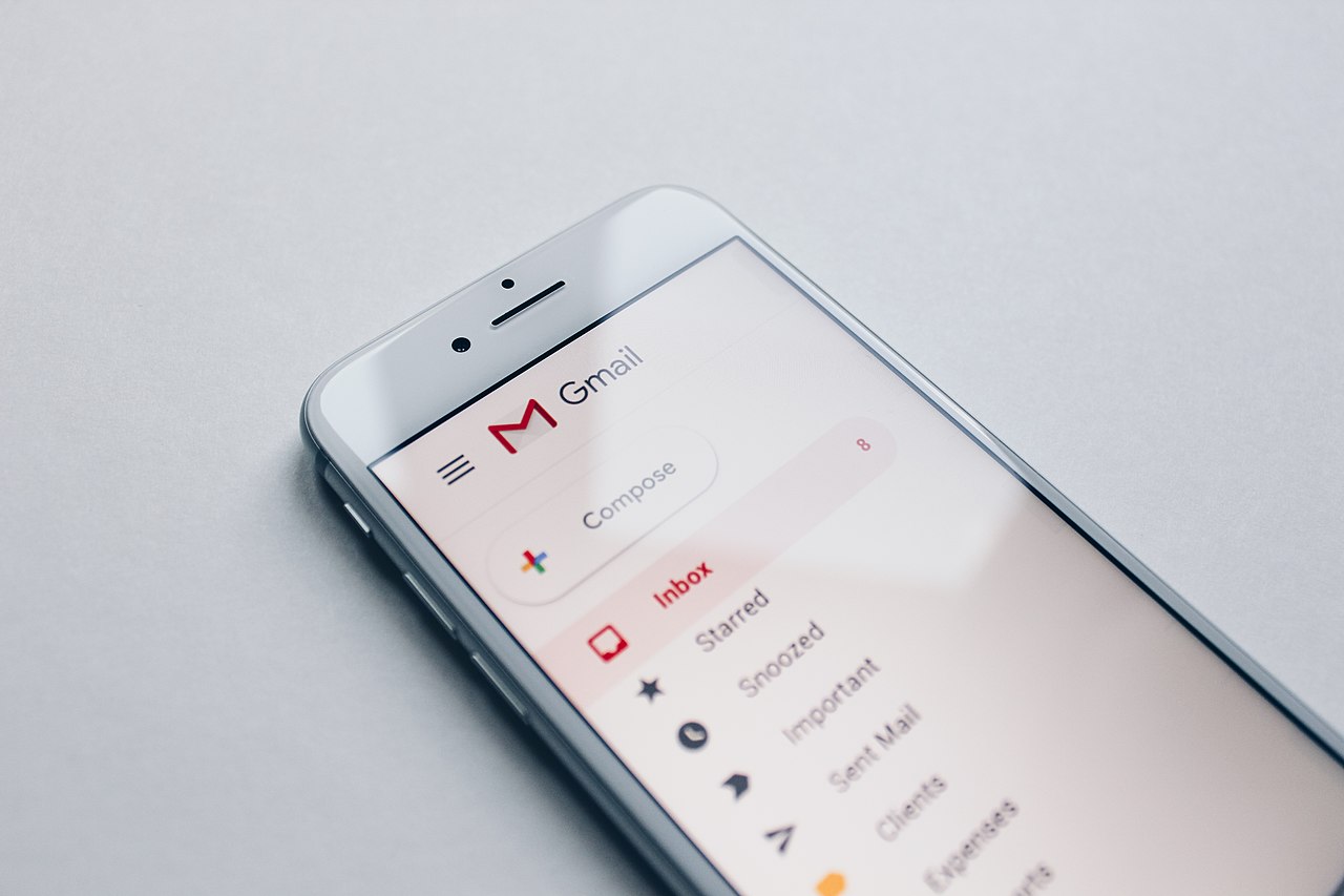 Close-up view of Gmail logo and interface on a computer screen showing the distinctive red and white email icon