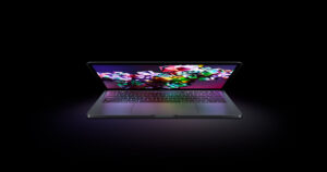 MacBook Pro laptop with open display showing colorful gradient wallpaper on screen, front-facing view on white background