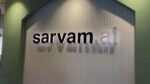 Sarvam AI logo signage displayed on textured wall at Bengaluru office headquarters showing company branding in black lettering