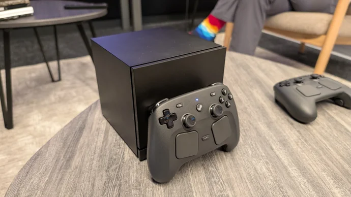 Valve Steam Machine console and new Steam Controller hardware announced November 2025 showing compact black PC design with controller featuring dual touchpads and analog sticks
