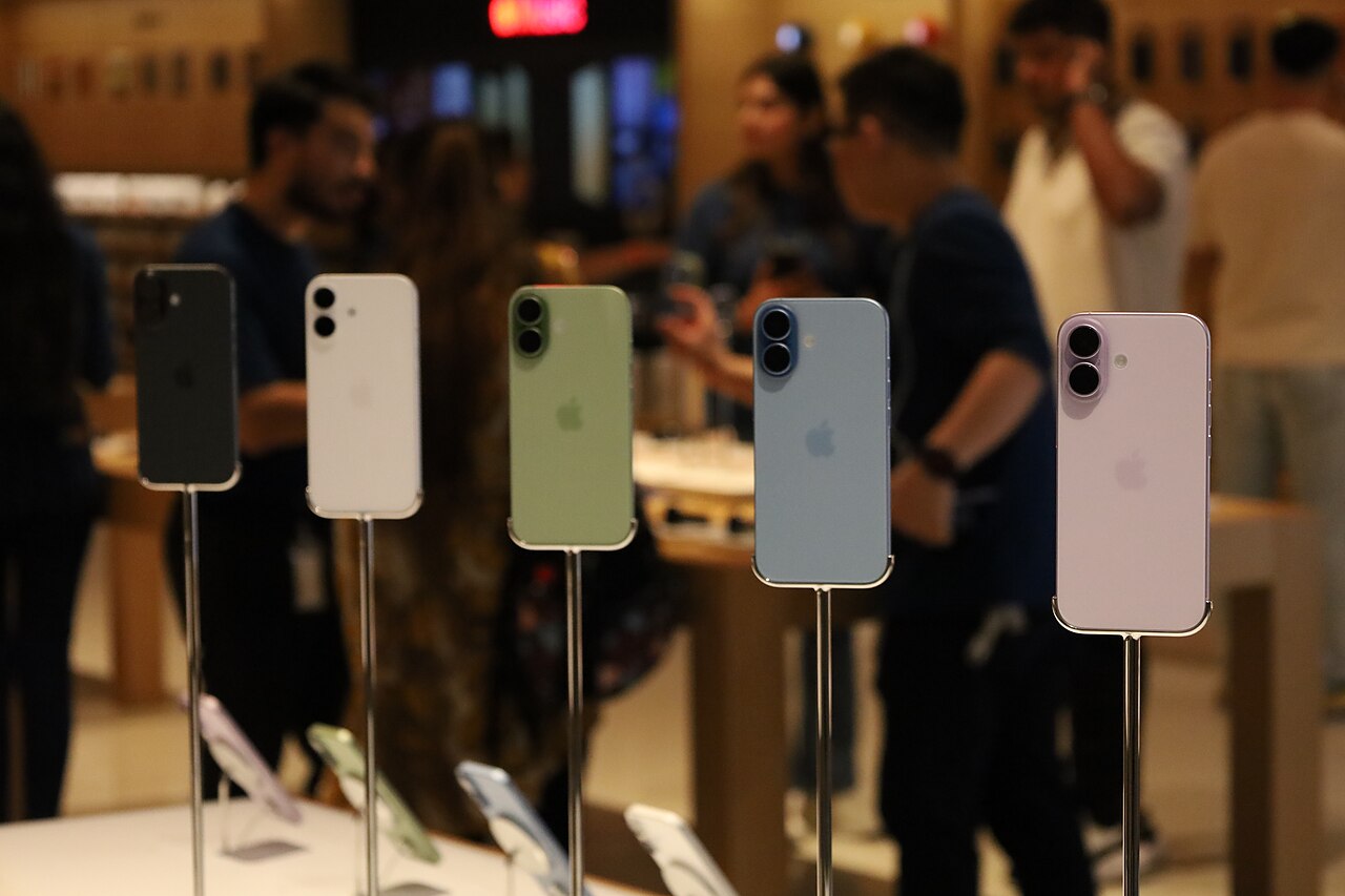 Customers queuing at Apple Store The Exchange TRX Malaysia during iPhone 17 launch with Apple staff assisting early morning crowd