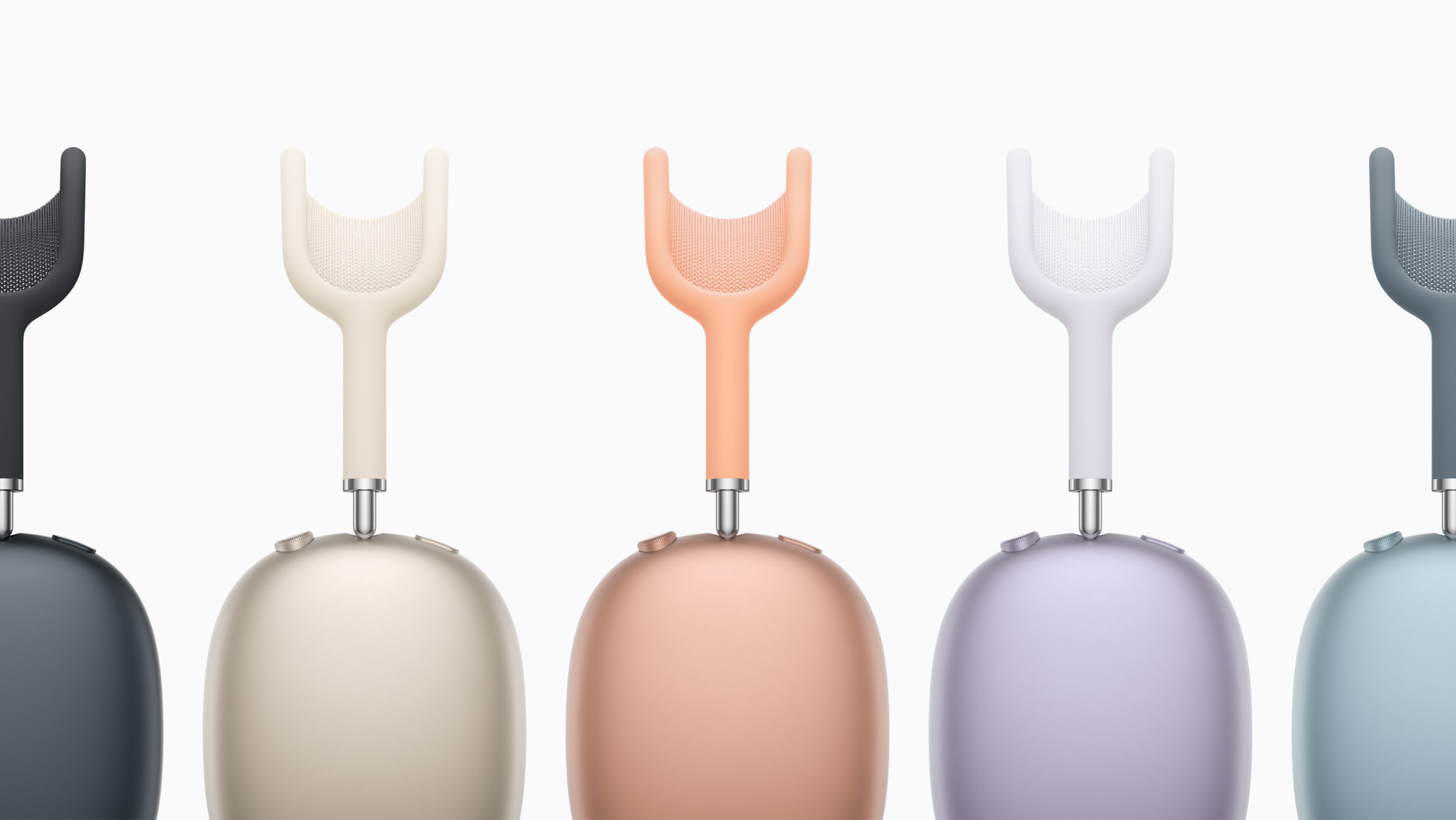 Five AirPods Max 2 headphones displayed side by side showing the full colour lineup from left to right: Midnight, Starlight, Orange, Purple, and Blue