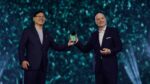 FIFA President Gianni Infantino and Lenovo Chairman and CEO Yuanqing Yang jointly hold a Lenovo device on stage at Lenovo Tech World 2026 at Sphere, Las Vegas, during the unveiling of the Football AI suite on 7 January 2026.