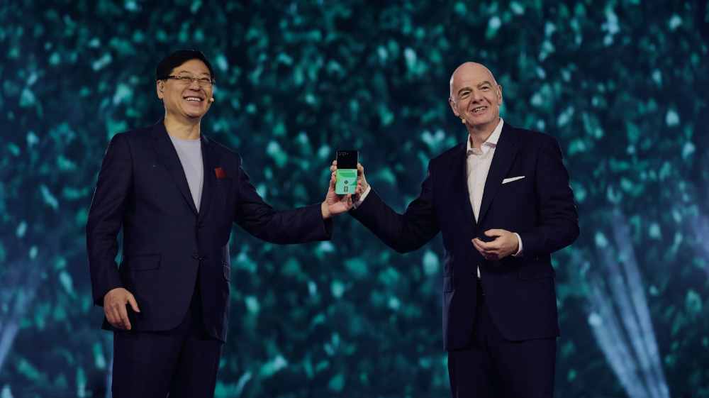 FIFA President Gianni Infantino and Lenovo Chairman and CEO Yuanqing Yang jointly hold a Lenovo device on stage at Lenovo Tech World 2026 at Sphere, Las Vegas, during the unveiling of the Football AI suite on 7 January 2026.
