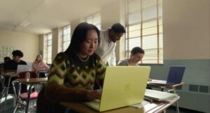 MacBook Neo battery life illustration showing 16 hours of usage on single charge with A18 Pro chip energy efficiency