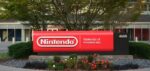 Red Nintendo sign at company headquarters entrance in Redmond Washington showing updated modern branding against landscaped grounds