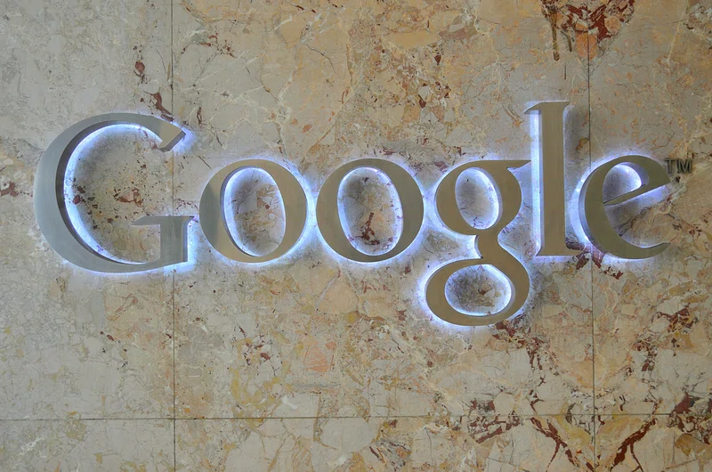 Industrial robotic arm operating on a manufacturing factory floor representing Physical AI automation and TCS Gemini Experience Center capabilities