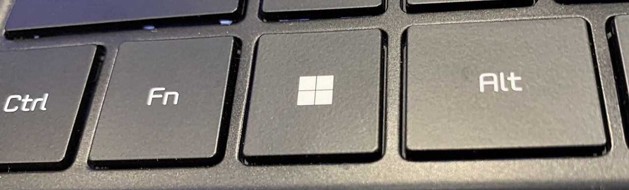 The Windows key on a keyboard built for Windows 11-compatible hardware, featuring the redesigned four-pane Windows 11 logo etched onto the key surface