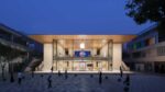 Exterior view of Apple Sanlitun store at Taikoo Li Sanlitun mall in Beijing China on opening day July 17 2020 showing glass facade staircase and outdoor plaza