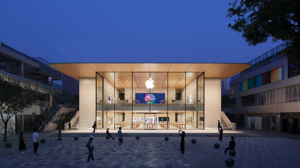 Exterior view of Apple Sanlitun store at Taikoo Li Sanlitun mall in Beijing China on opening day July 17 2020 showing glass facade staircase and outdoor plaza