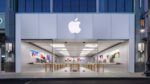 Interior of an Apple retail store displaying iPhone 16 products and promotional materials for Apple Intelligence features