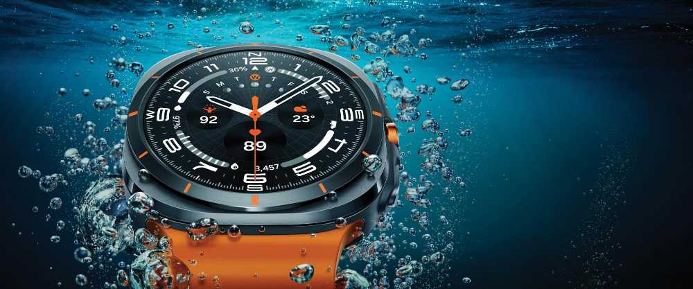 A Samsung Galaxy Watch Ultra in a titanium gray finish on a dark background with a digital interface display.