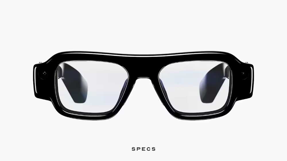 Snap Specs augmented reality glasses in 52mm frame displayed against dark background showing front view of electrochromic lenses and Swiss TR90 polymer frame design