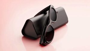 Meta Starfire Kylie Edition smart glasses in classic black resting beside their matching charging case.