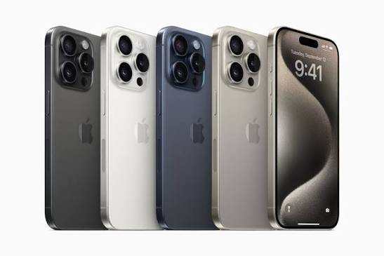 iPhone 15 Pro and iPhone 15 Pro Max in four titanium finishes: black, white, blue, and natural, displayed against a dark background.
